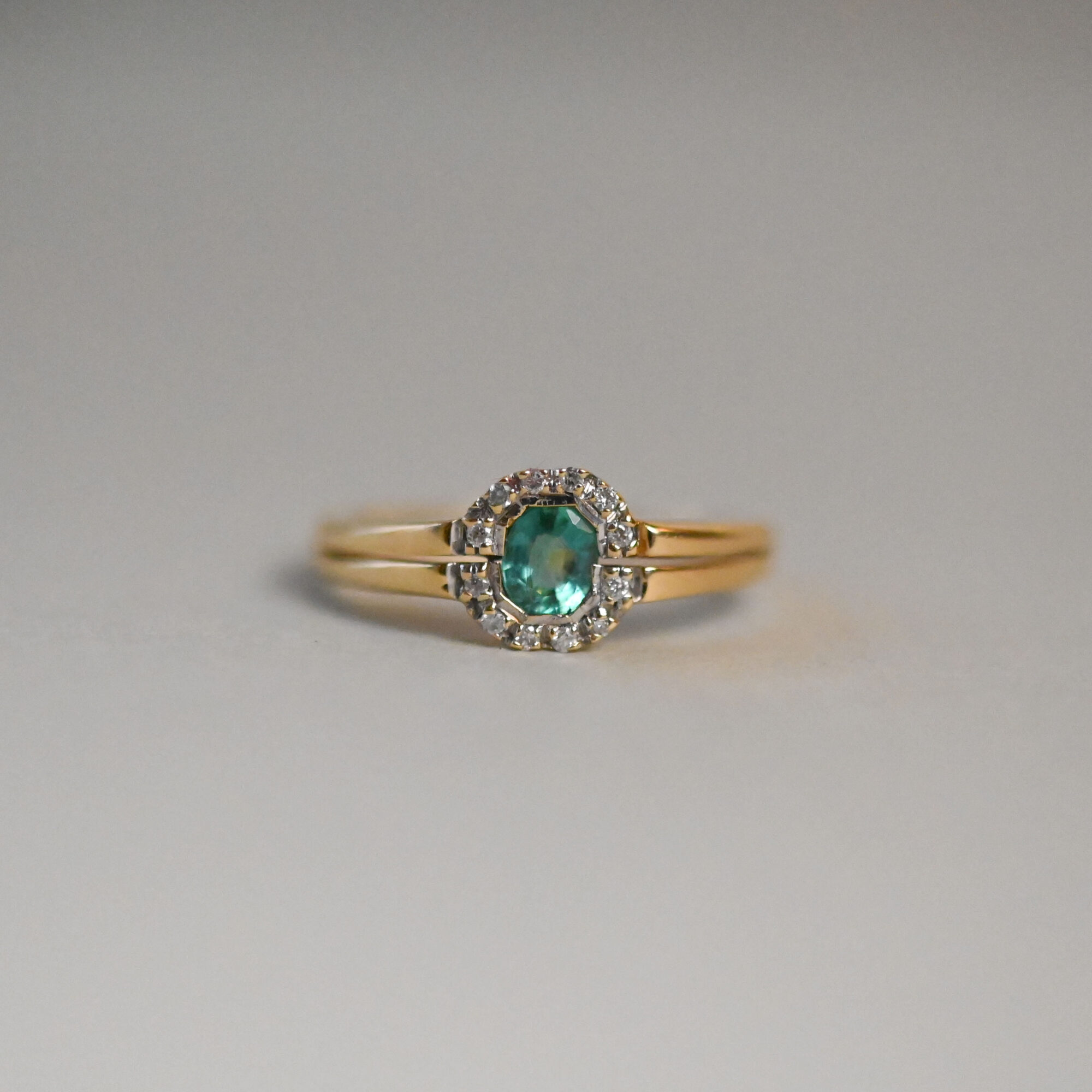 Contemporary 18ct gold blue green tourmaline and mini diamond halo ring