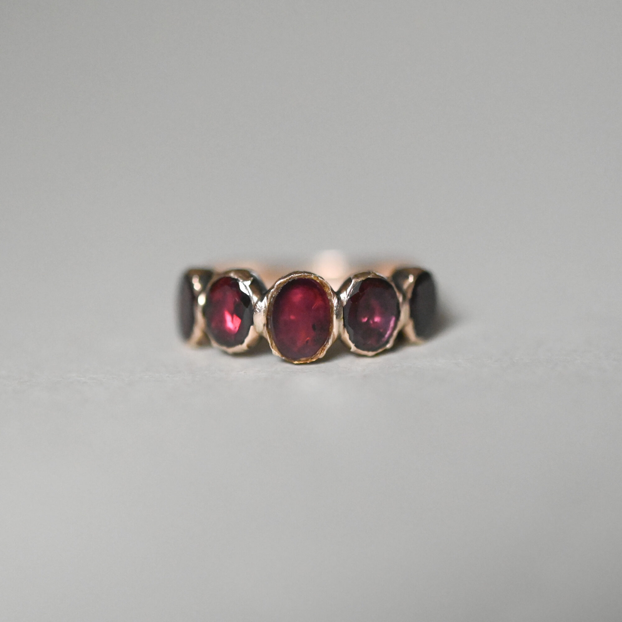 Contemporary Georgian design 9ct gold five stone flat cut garnet half hoop ring