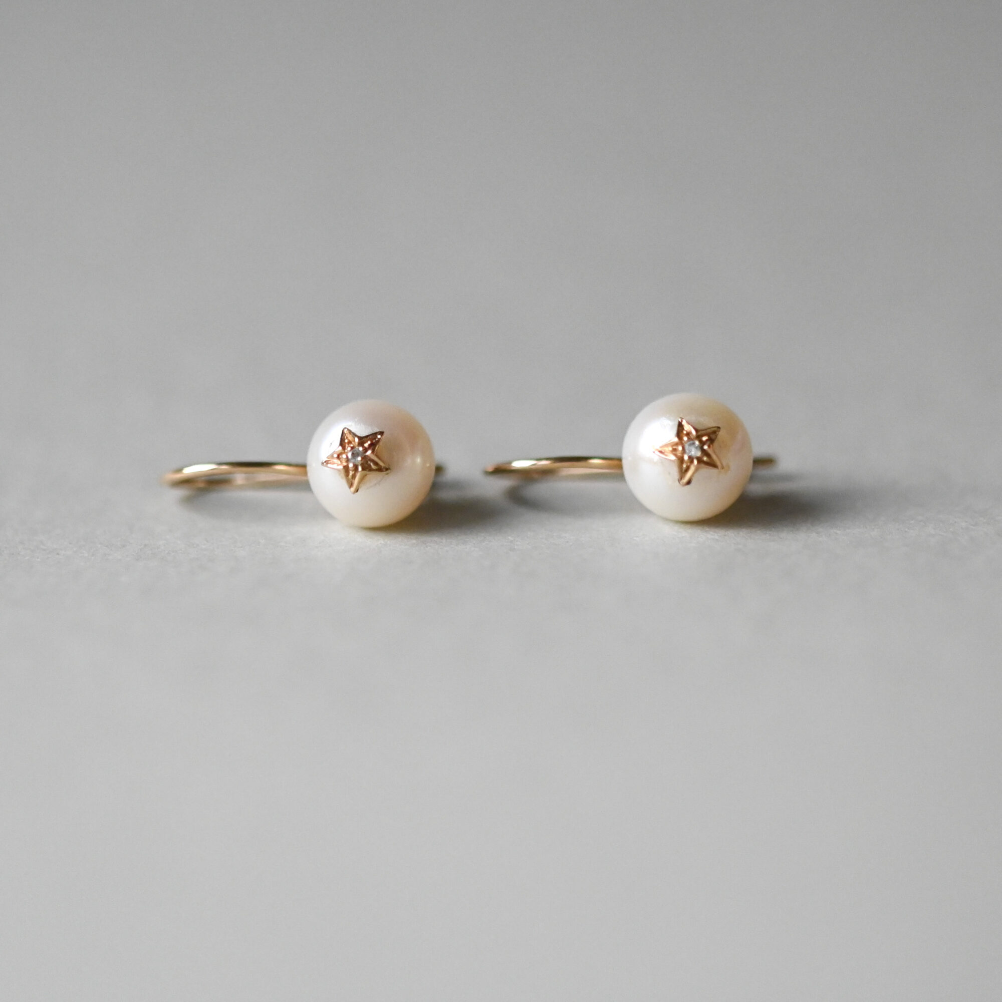 Contemporary pair of 9ct gold pearl and mini diamond starburst earrings