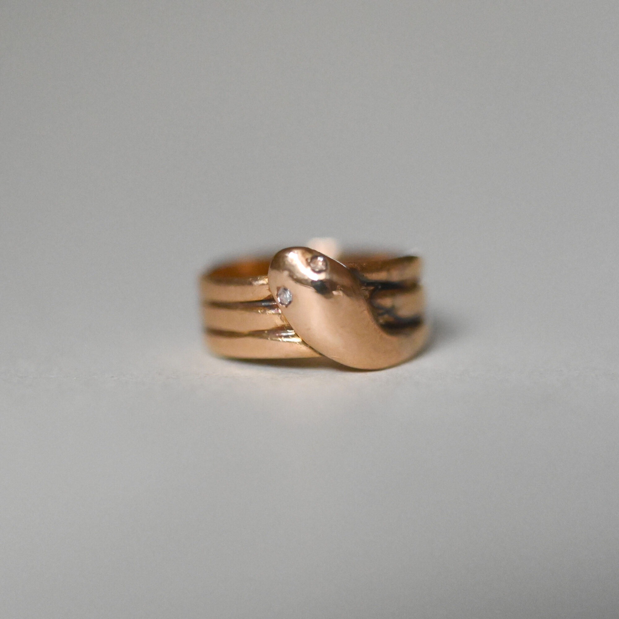 Edwardian 18ct gold snake ring with diamond eyes, 1905