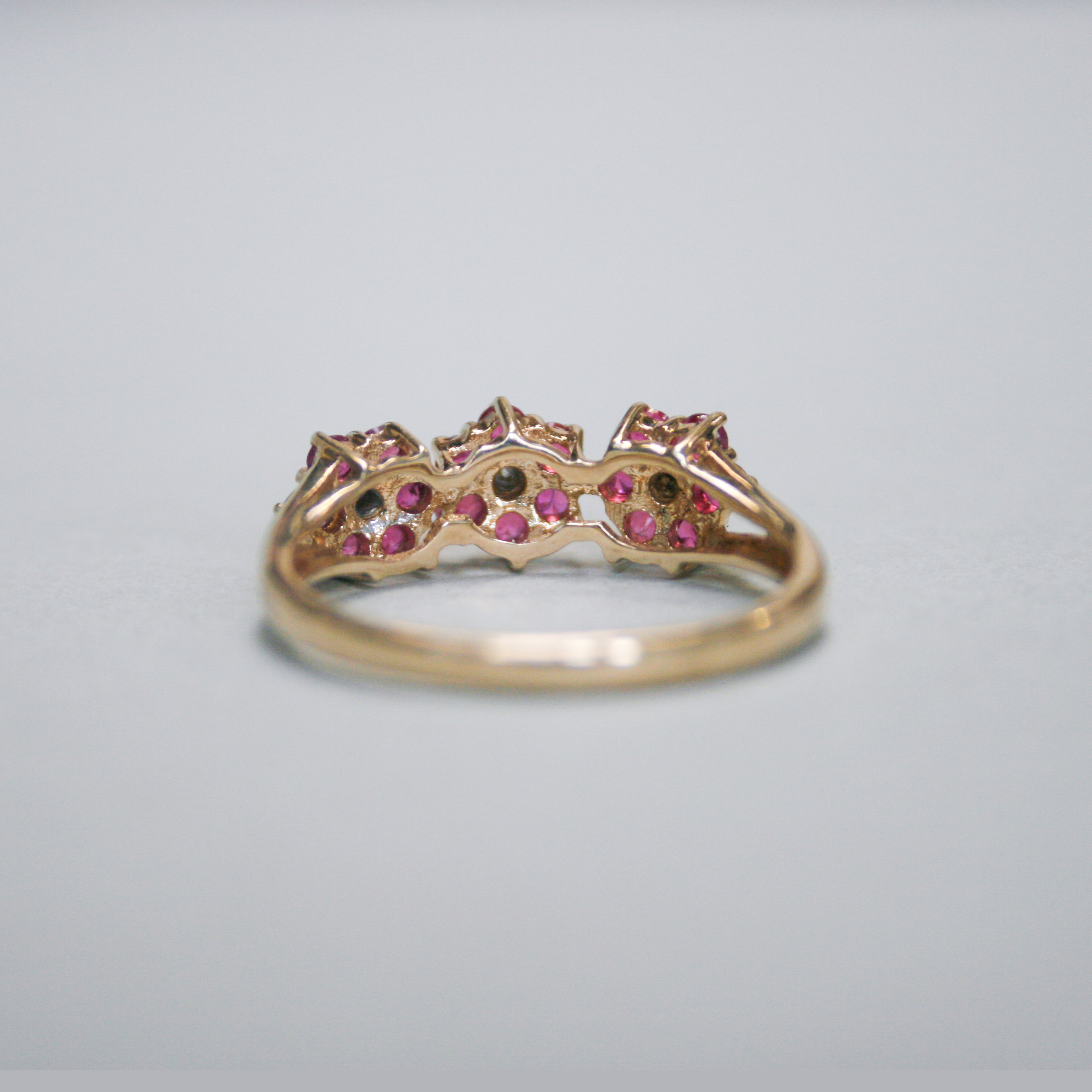 Contemporary 9ct gold ruby and mini diamond triple cluster ring - Image 3