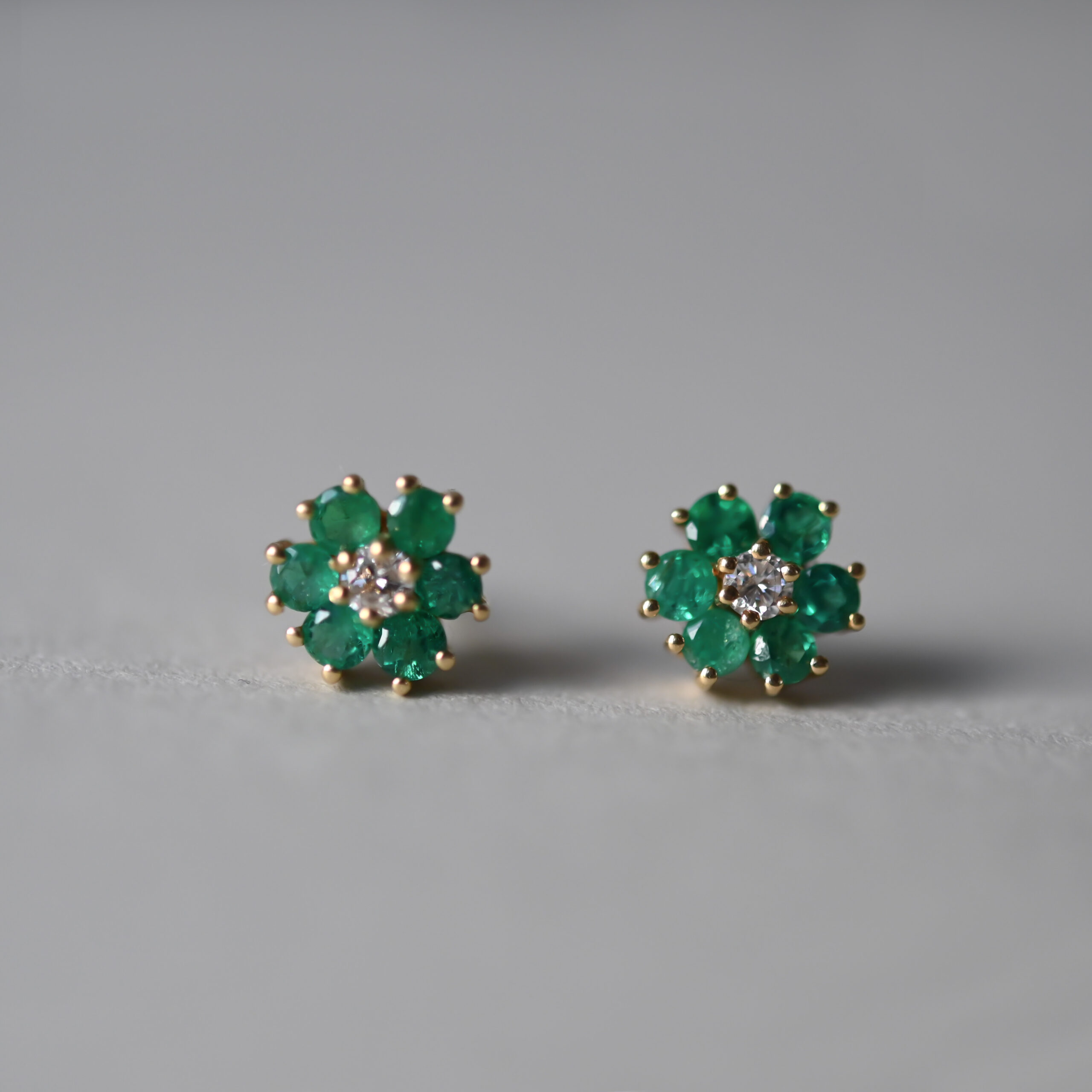 Classic pair of 14ct gold emerald and diamond cluster earrings