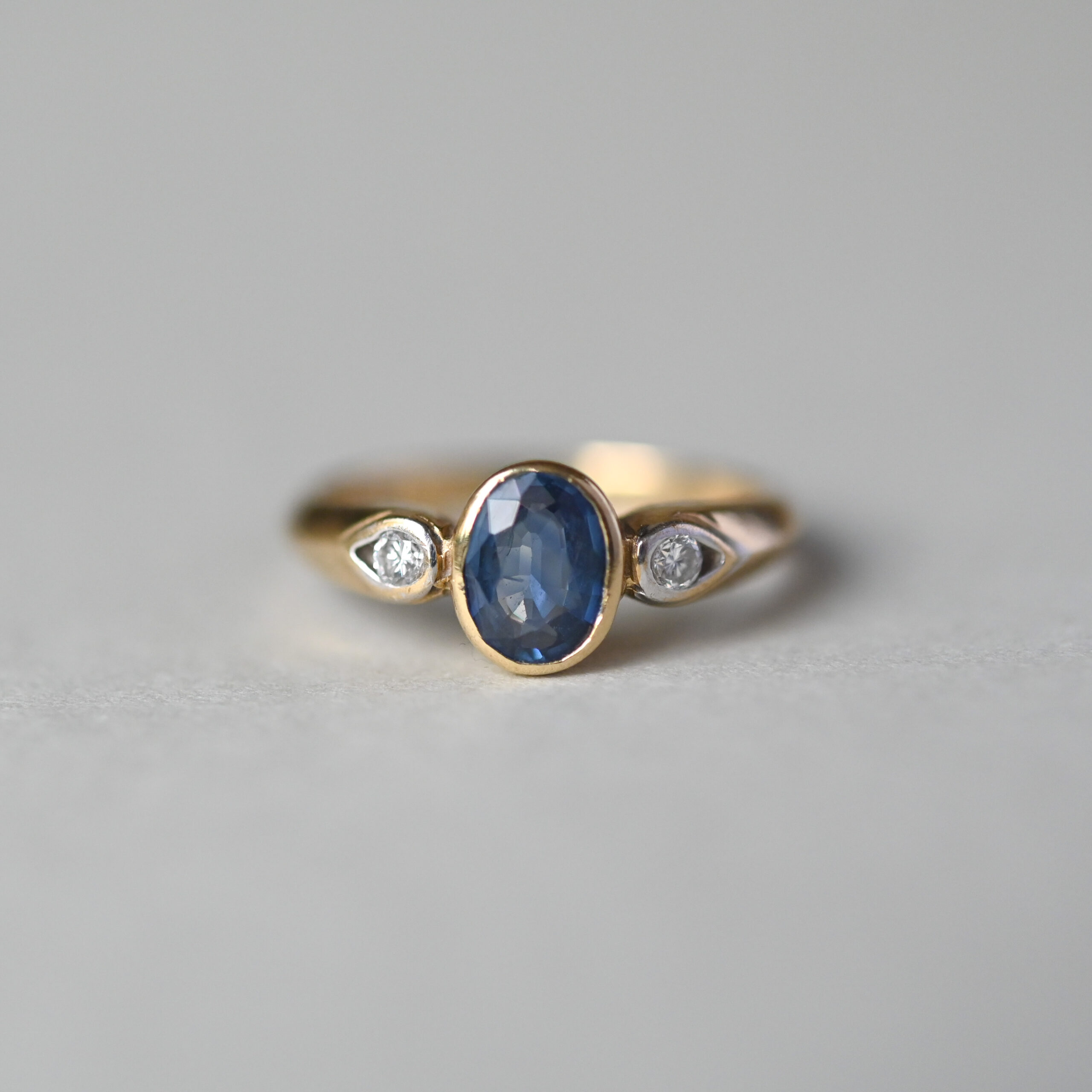 Contemporary 9ct gold sapphire and diamond three stone ring